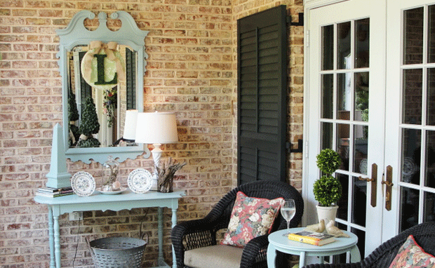 painted furniture, wicker chairs and floral patterned fabrics on a Cottage Coastal porch